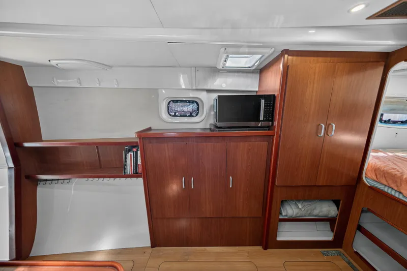 Slide: The Image of Interior of a 2012 Leopard 39 yacht with wooden cabinetry and a microwave. - 29