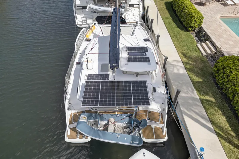 Slide: The Image of Overhead view of a 2012 Leopard 39 catamaran with solar panels docked by a pool. - 3