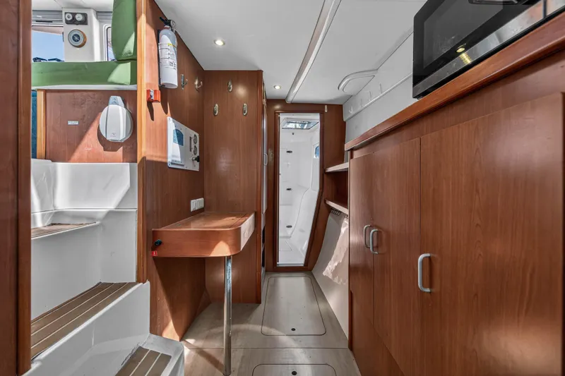 Slide: The Image of Interior of 2012 Leopard 39 yacht with wooden cabinetry and modern amenities. - 30