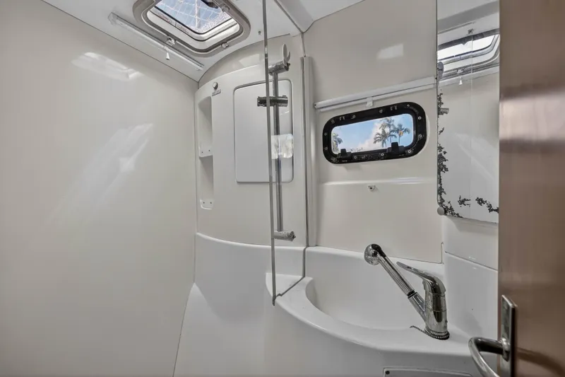 Slide: The Image of Bathroom interior of a 2012 Leopard 39 yacht with modern fixtures and porthole window. - 34