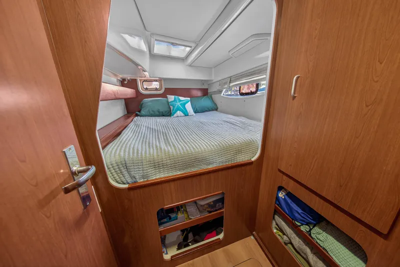 Slide: The Image of Cozy cabin interior of 2012 Leopard 39 yacht with bed and wooden furnishings. - 35