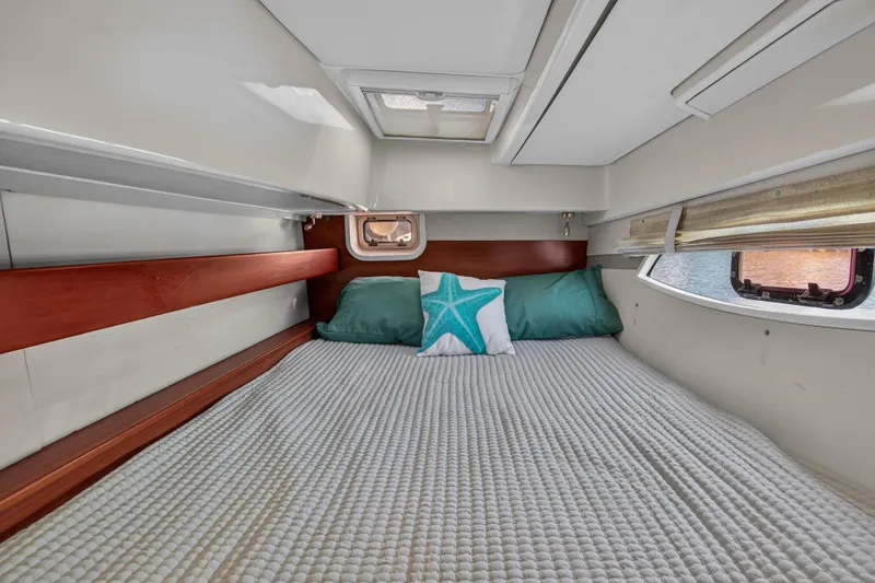 Slide: The Image of Cozy cabin interior of 2012 Leopard 39 yacht with bed and starfish pillow. - 36
