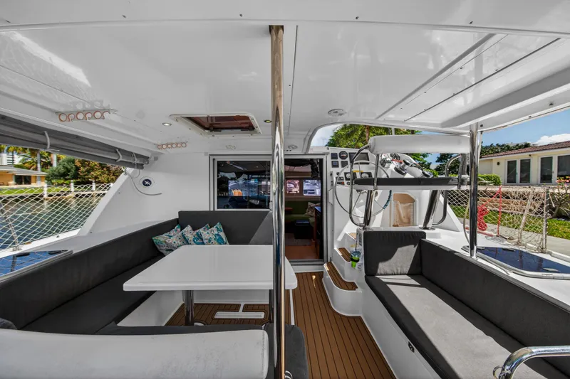 Slide: The Image of 2012 Leopard 39 catamaran interior with seating, table, and helm station. - 4