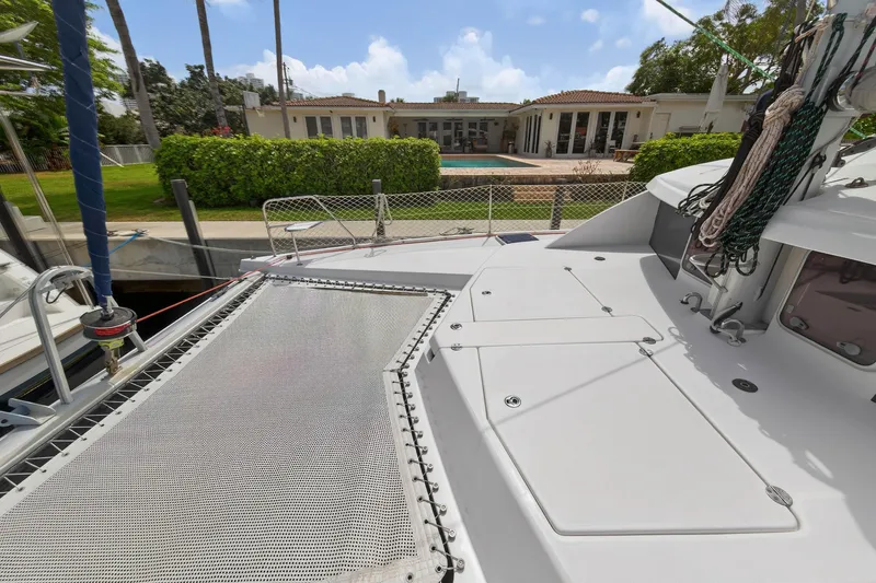 Slide: The Image of Leopard 39 catamaran deck, 2012 model, docked near a luxurious waterfront home. - 42