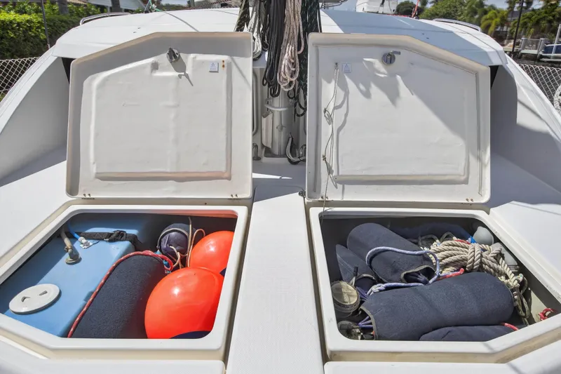 Slide: The Image of Open storage compartments on a 2012 Leopard 39 boat, containing ropes and safety equipment. - 45