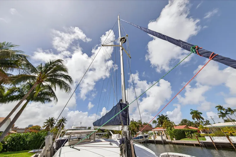 Slide: The Image of Sailboat Leopard 39, 2012 model, docked under a sunny sky with palm trees. - 47