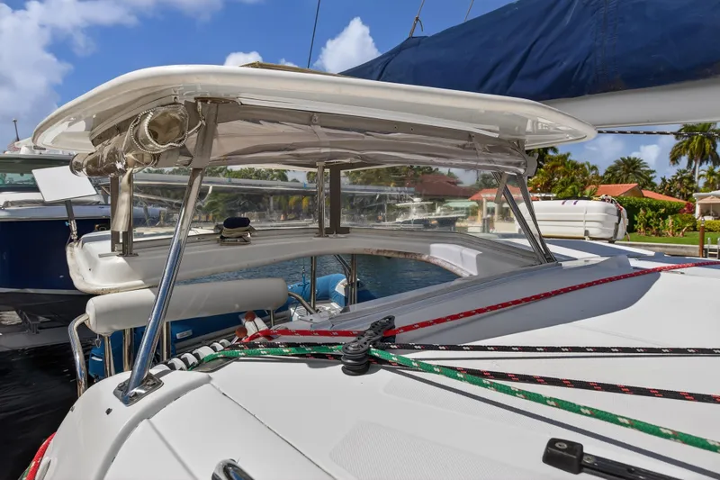 Slide: The Image of 2012 Leopard 39 sailboat deck with ropes and canopy, docked in a sunny marina. - 68