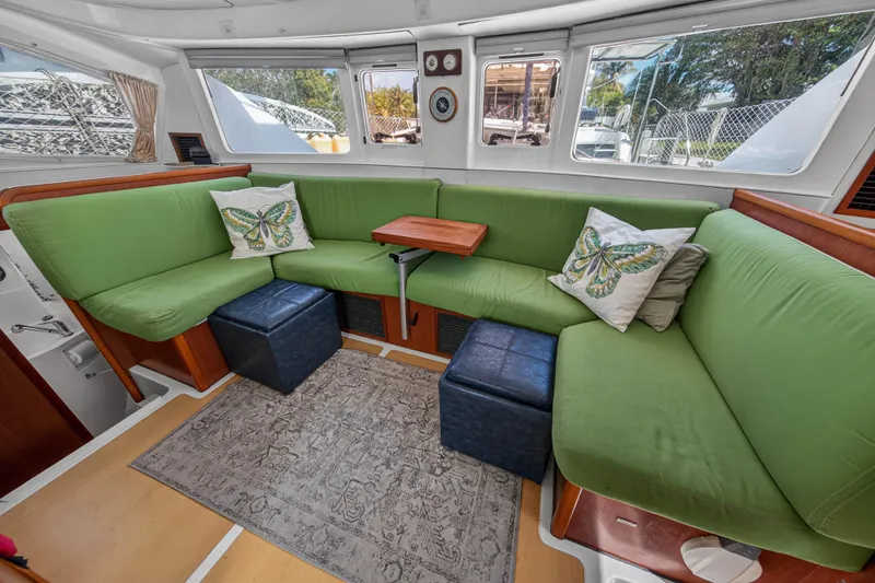 Slide: The Image of Luxurious 2012 Leopard 39 yacht interior with green seating, butterfly pillows, and large windows. - 70