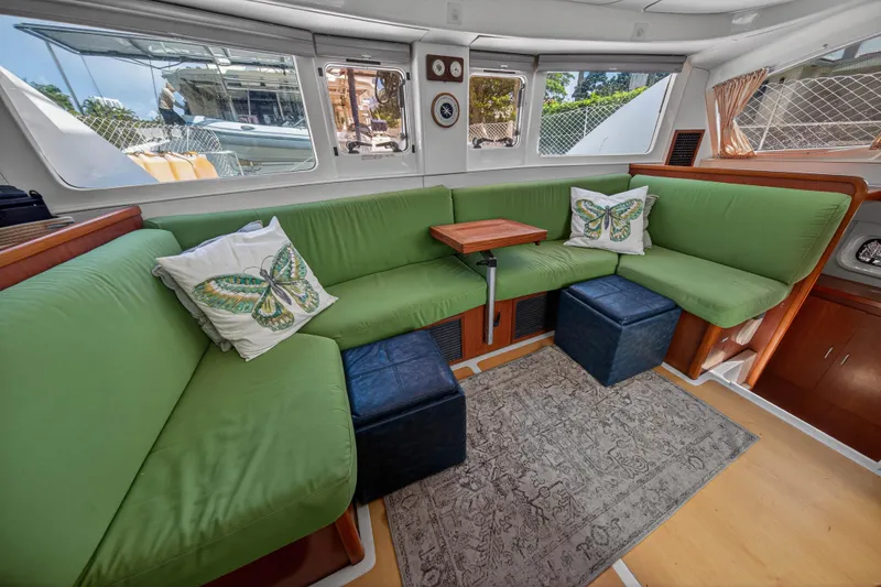 Slide: The Image of Interior of 2012 Leopard 39 yacht with green seating, butterfly pillows, and wooden accents. - 71
