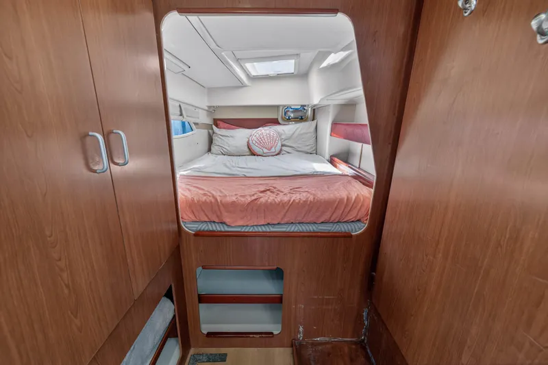 Slide: The Image of Cozy cabin interior of 2012 Leopard 39 yacht with wooden finish and comfortable bedding. - 82