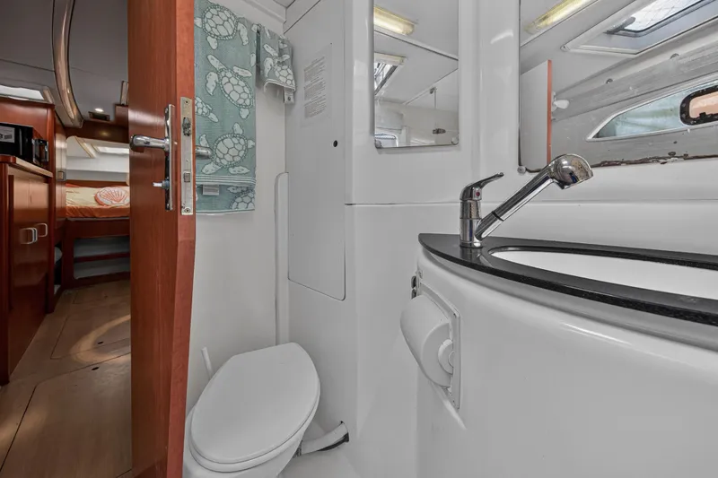 Slide: The Image of Interior of 2012 Leopard 39 yacht bathroom with sink, toilet, and cabin view. - 87