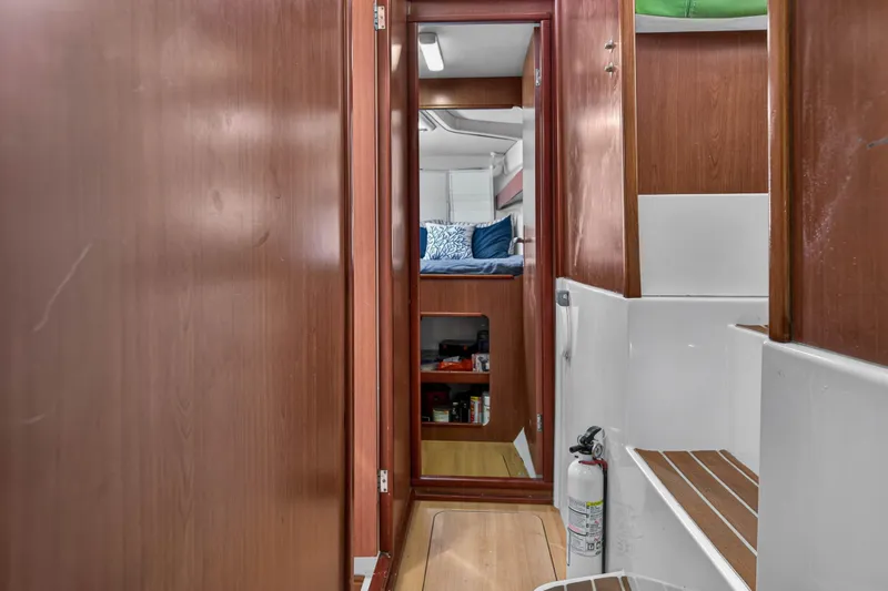 Slide: The Image of Interior of 2012 Leopard 39 yacht, featuring wooden paneling and cozy cabin space. - 95