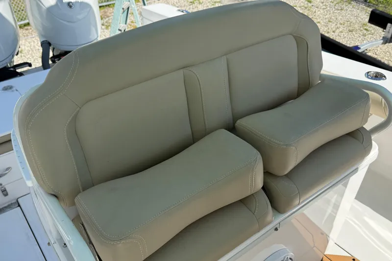 Slide: The Image of 2022 Everglades 273 Center Console boat seat with beige upholstery and armrests. - 15