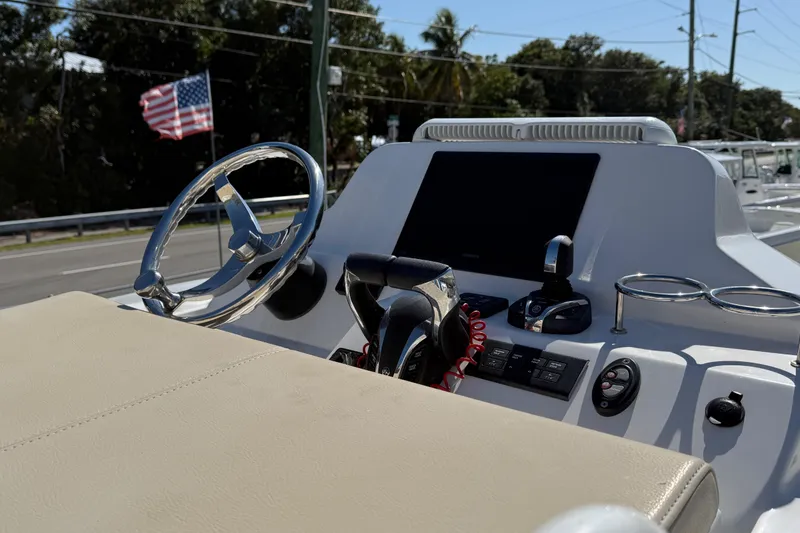 Slide: The Image of 2022 Everglades 273 Center Console boat dashboard with steering wheel and controls. - 19
