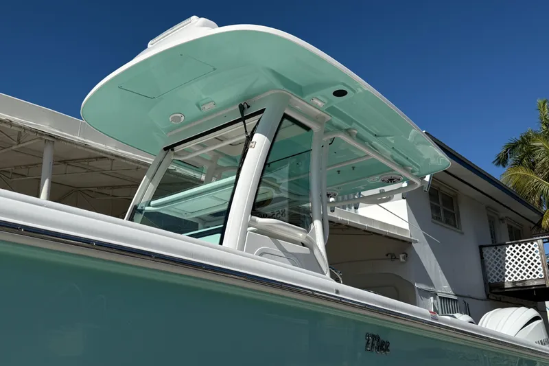 Slide: The Image of 2022 Everglades 273 Center Console boat with sleek design under clear blue sky. - 2