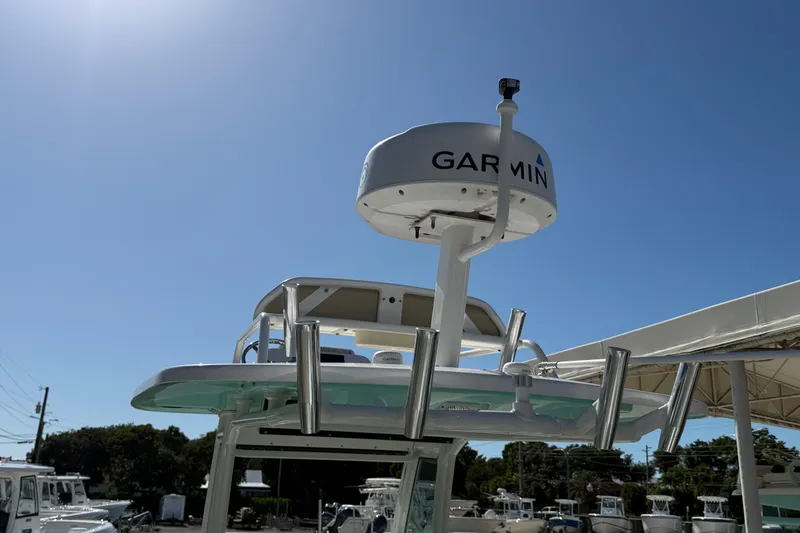Slide: The Image of 2022 Everglades 273 Center Console boat with Garmin radar under clear blue sky. - 20