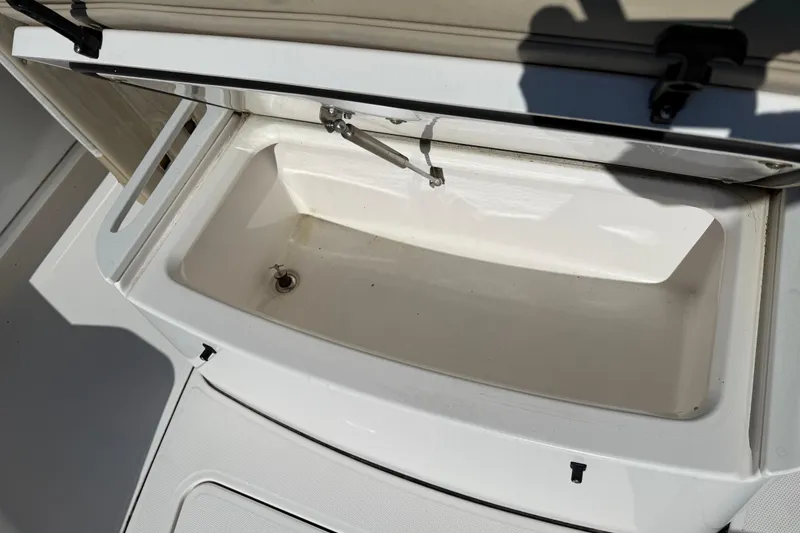 Slide: The Image of Open storage compartment on 2022 Everglades 273 Center Console boat. - 21