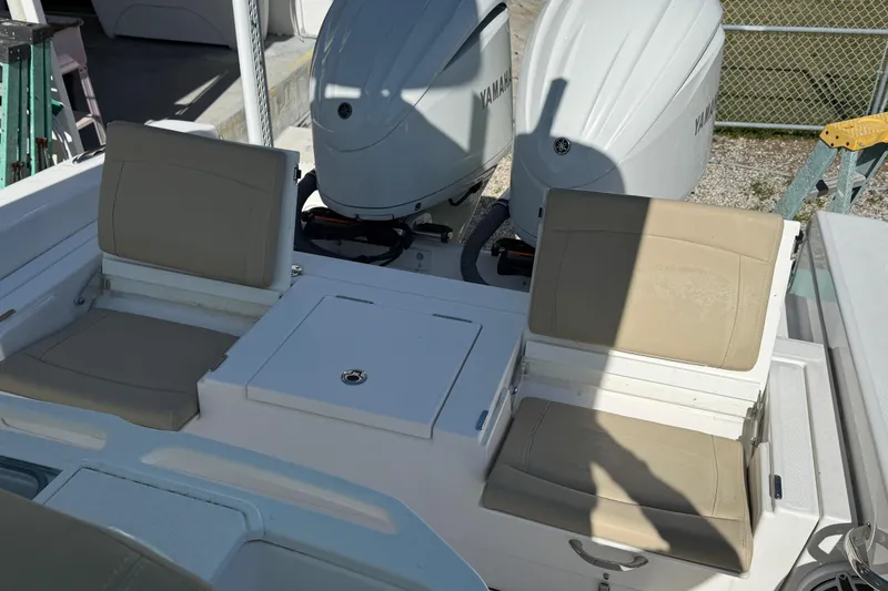 Slide: The Image of 2022 Everglades 273 Center Console boat with dual Yamaha engines and beige seating. - 22
