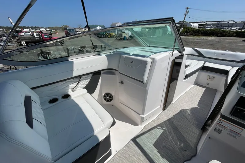Slide: The Image of 2018 Regal 26 OBX boat interior with white seating and modern dashboard. - 11