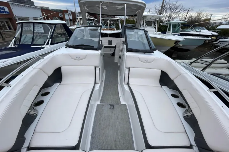 Slide: The Image of 2017 Chaparral 307 SSX boat interior with white seating and cup holders. - 12