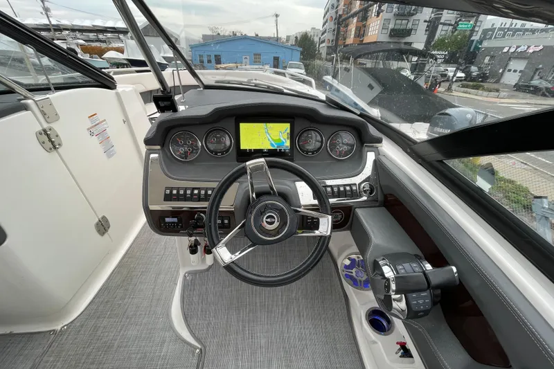 Slide: The Image of Cockpit of 2017 Chaparral 307 SSX boat with steering wheel and navigation display. - 6