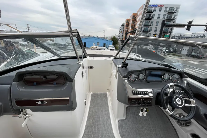 Slide: The Image of 2017 Chaparral 307 SSX boat cockpit with modern dashboard and steering wheel. - 8