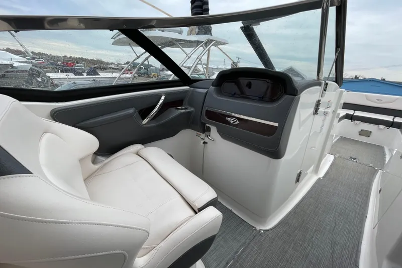 Slide: The Image of 2017 Chaparral 307 SSX boat interior with sleek dashboard and comfortable seating. - 9