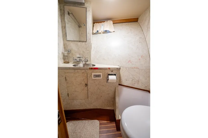 Slide: The Image of Bathroom interior of a 1958 Rybovich 54 Yachtfish, featuring a sink and mirror. - 16