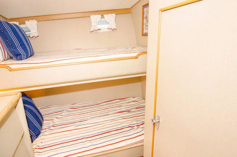 Slide: The Image of Interior of 1958 Rybovich 54 Yachtfish with cozy bunk beds and nautical decor. - 11