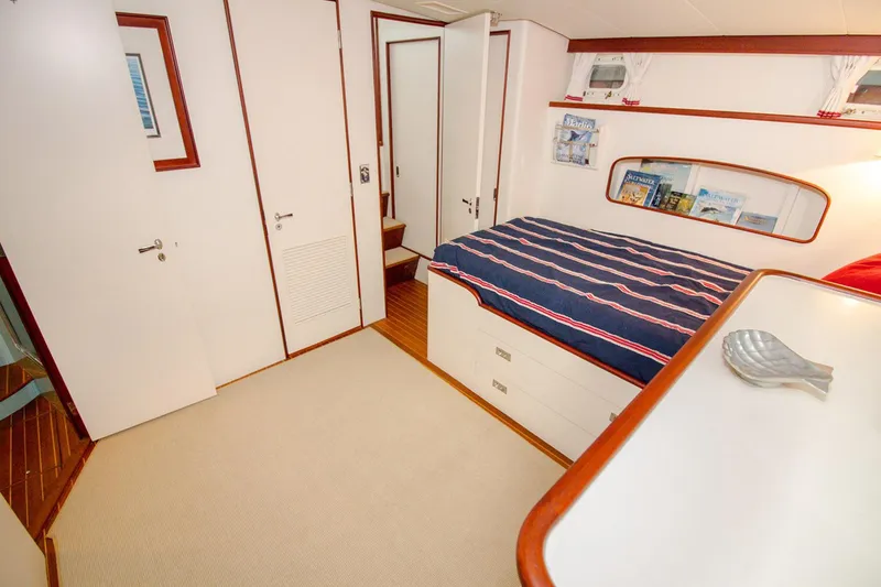 Slide: The Image of 1958 Rybovich 54 Yachtfish cabin with bed, wooden accents, and nautical decor. - 14