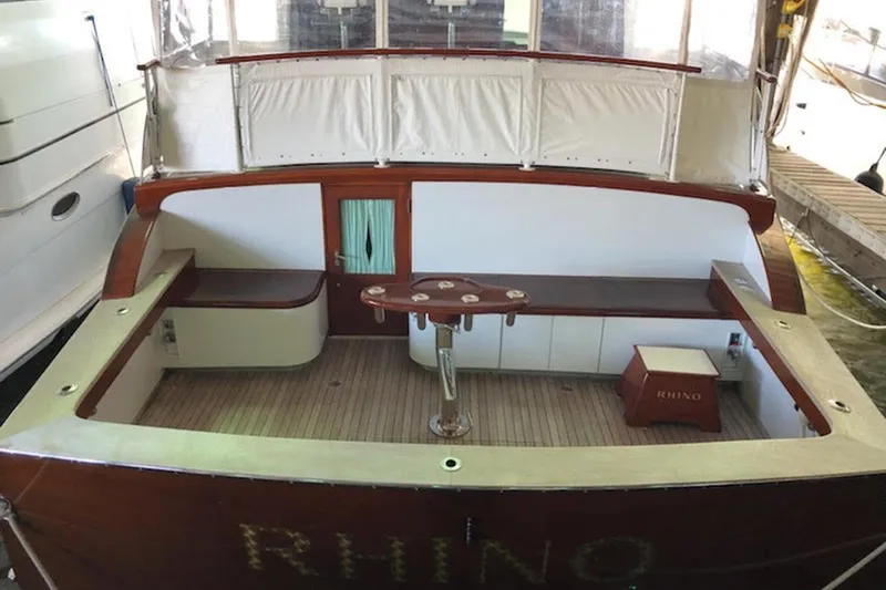 Slide: The Image of 1958 Rybovich 54 Yachtfish deck with wooden accents and seating area. - 16