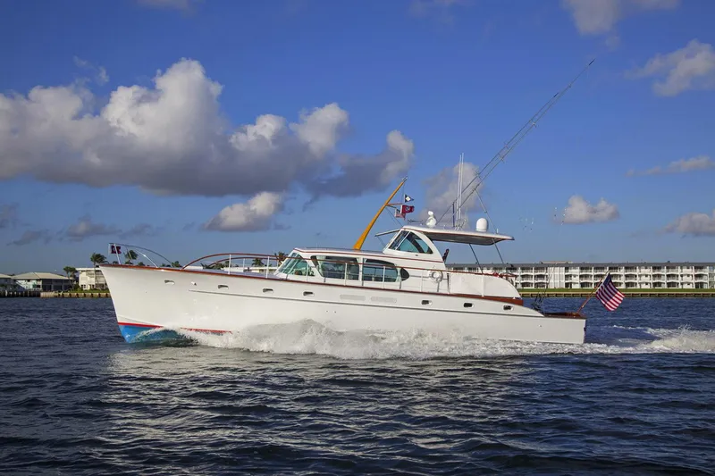 Slide: The Image of 1958 Rybovich 54 Yachtfish cruising on open water under a clear blue sky. - 20