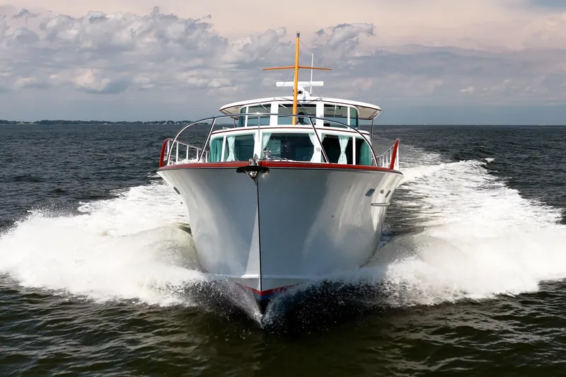 Slide: The Image of 1958 Rybovich 54 Yachtfish cruising on open water under a cloudy sky. - 11
