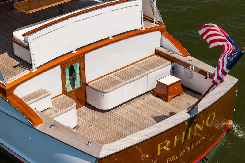 Slide: The Image of 1958 Rybovich 54 Yachtfish with teak deck, American flag, and elegant wood accents. - 7