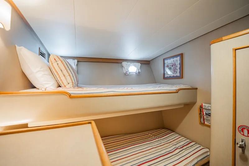 Slide: The Image of Cozy cabin interior of 1958 Rybovich 54 Yachtfish with bunk beds and nautical decor. - 17