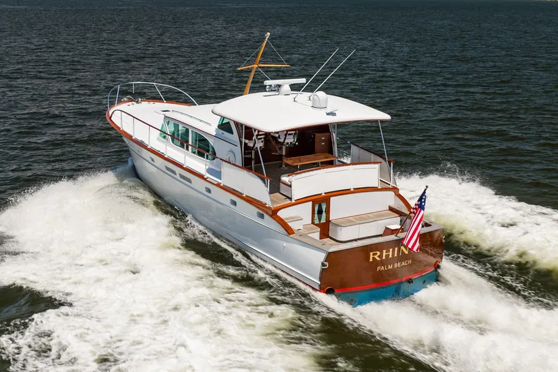 Slide: The Image of 1958 Rybovich 54 Yachtfish cruising on open water, displaying classic design and American flag. - 10