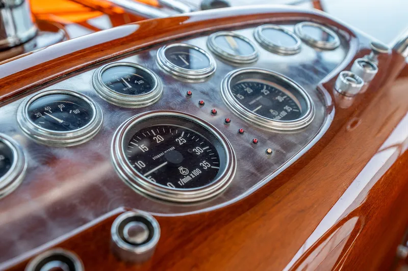 Slide: The Image of Vintage 1958 Rybovich 54 Yachtfish dashboard with classic gauges and polished wood finish. - 9