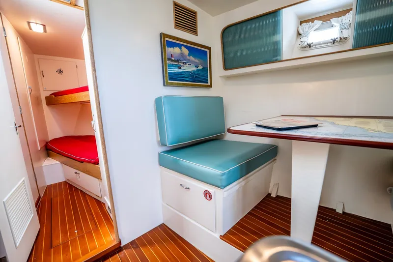 Slide: The Image of Interior of a 1958 Rybovich 54 Yachtfish with cozy seating and wooden flooring. - 15