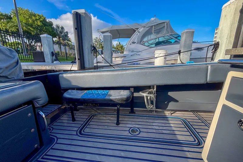 Slide: The Image of 2016 Hydra-Sports 4200 Siesta boat interior with seating and docked yacht in background. - 12