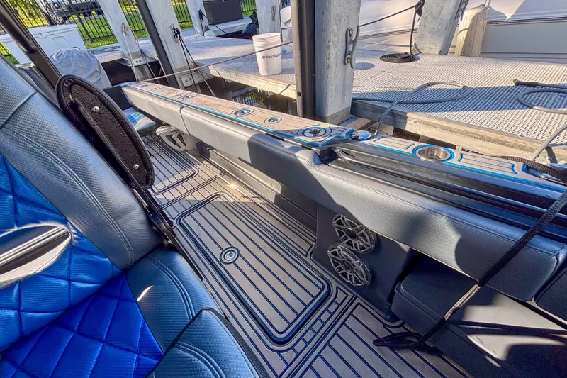 Slide: The Image of 2016 Hydra-Sports 4200 Siesta boat interior with blue seating and cup holders. - 18