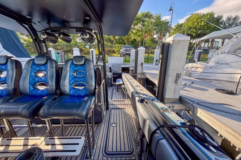Slide: The Image of 2016 Hydra-Sports 4200 Siesta boat interior with blue leather seats at a dock. - 28