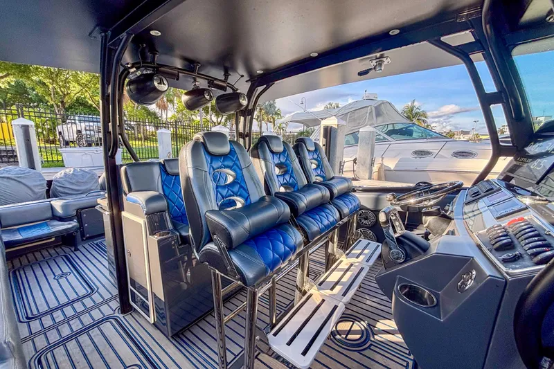 Slide: The Image of 2016 Hydra-Sports 4200 Siesta boat interior with blue seating and modern controls. - 31