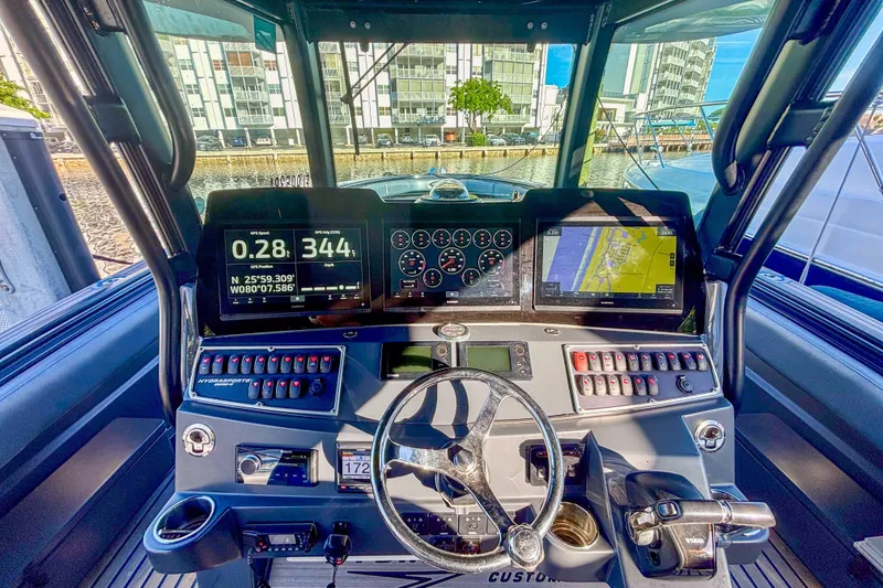 Slide: The Image of 2016 Hydra-Sports 4200 Siesta boat dashboard with navigation screens and controls. - 35