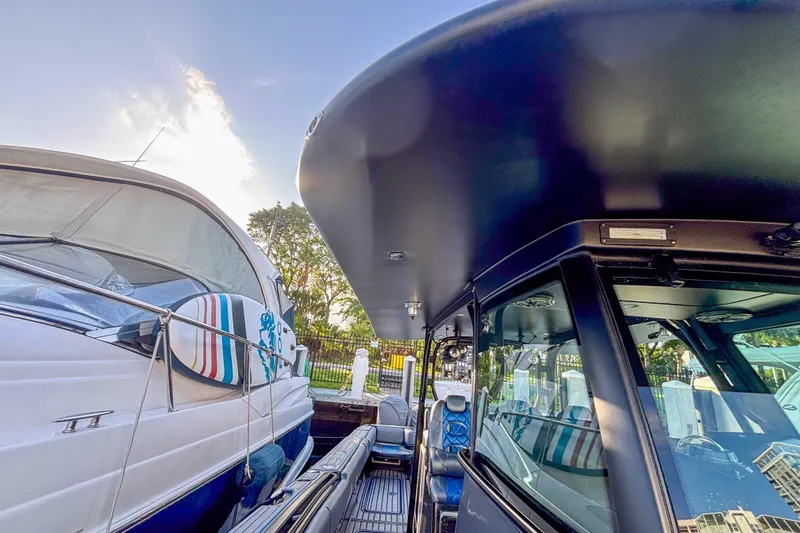 Slide: The Image of 2016 Hydra-Sports 4200 Siesta docked beside another boat, showcasing sleek design. - 44