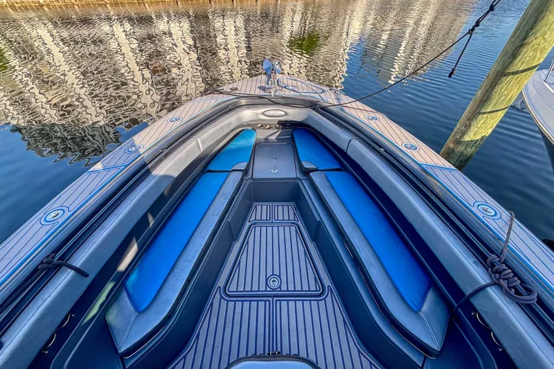 Slide: The Image of 2016 Hydra-Sports 4200 Siesta boat interior with blue seating, docked on calm water. - 48