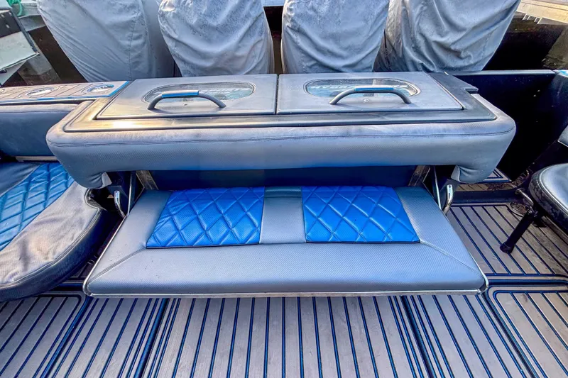 Slide: The Image of 2016 Hydra-Sports 4200 Siesta boat seating with blue cushions and storage compartment. - 6