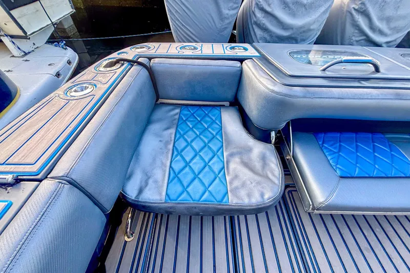 Slide: The Image of 2016 Hydra-Sports 4200 Siesta boat interior with blue cushioned seating and cup holders. - 7