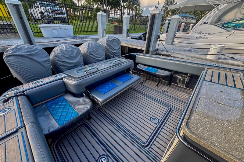 Slide: The Image of 2016 Hydra-Sports 4200 Siesta boat interior with cushioned seating and covered engines. - 8
