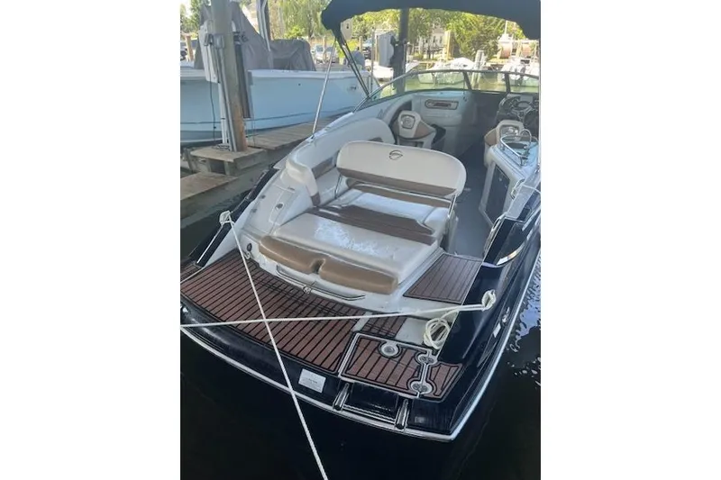 Slide: The Image of 2015 Crownline Eclipse E6 boat with spacious seating and sleek design at a dock. - 2