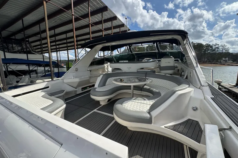 Slide: The Image of 1996 Sea Ray 500 Sedan Bridge yacht with spacious seating and elegant design under a covered dock. - 10